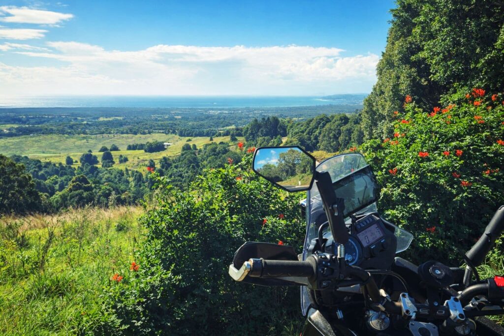 View from sitting on a motorbike looking out over Byron Bay hinterland and Ocean